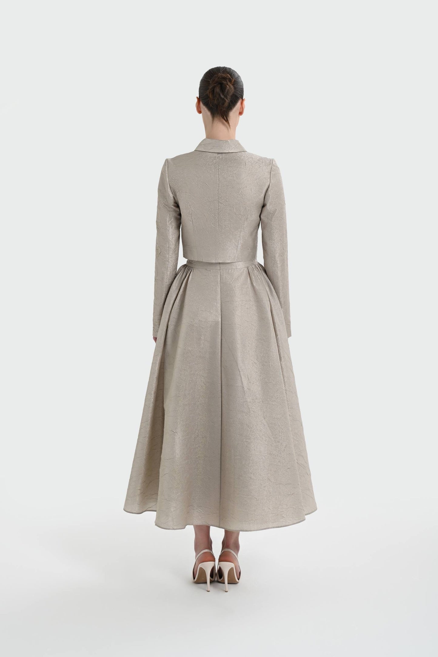 Elegant champagne two-piece set featuring a structured top and a flowing A-line skirt. 9175