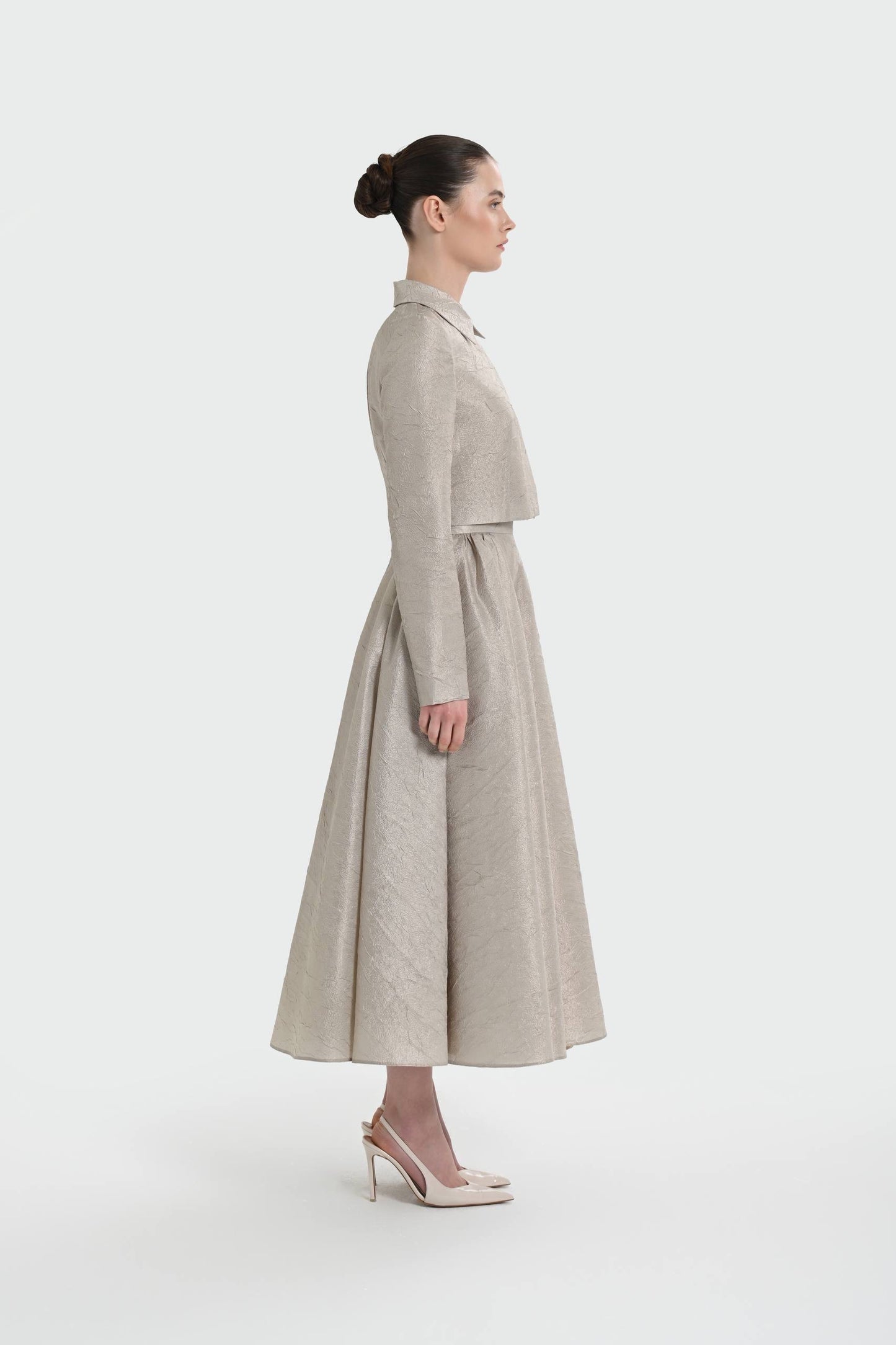 Elegant champagne two-piece set featuring a structured top and a flowing A-line skirt. 9175