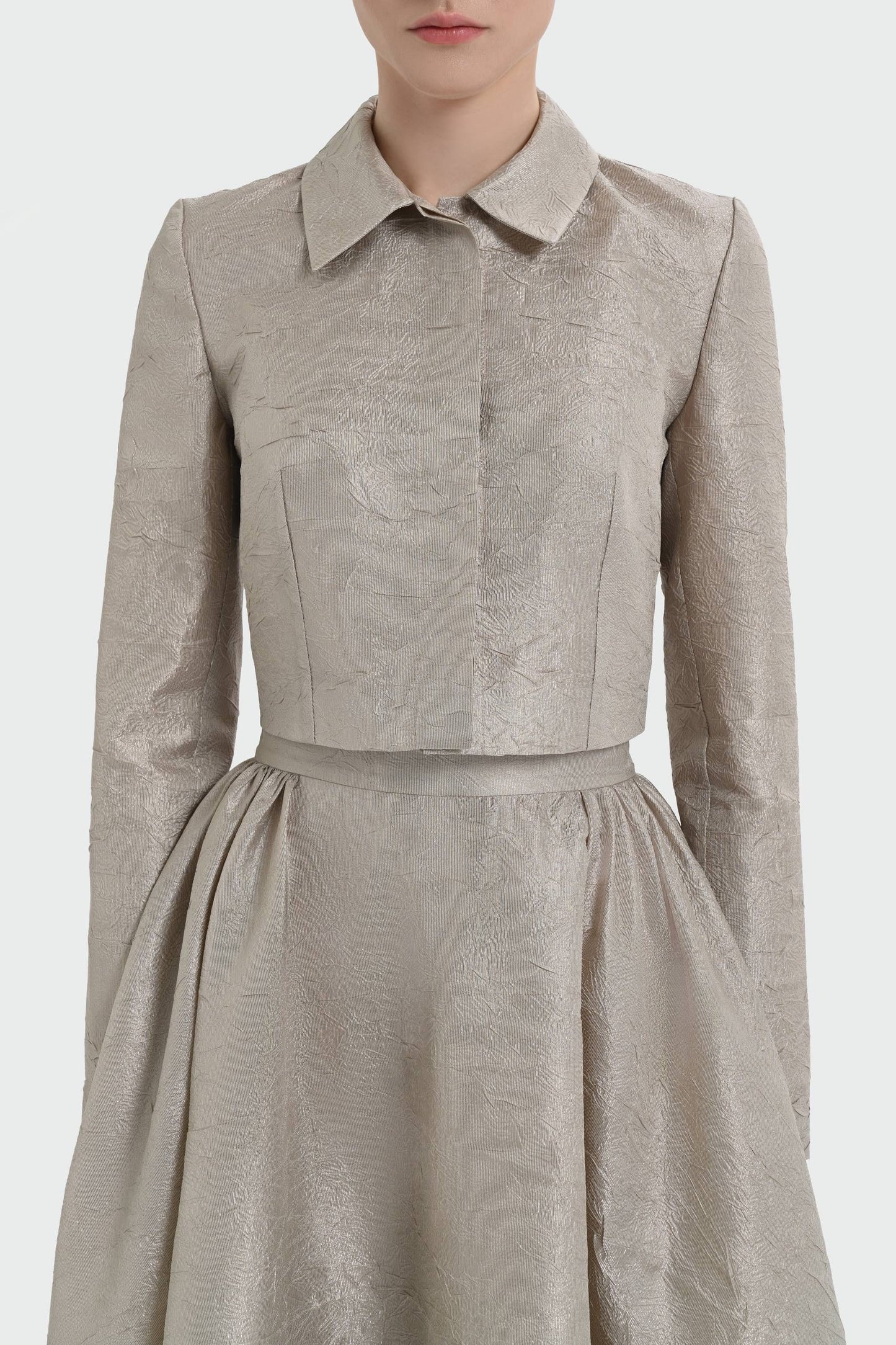 Elegant champagne two-piece set featuring a structured top and a flowing A-line skirt. 9175