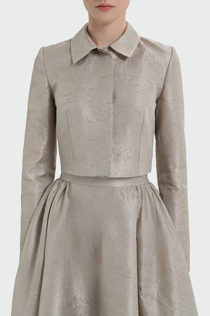 Elegant champagne two-piece set featuring a structured top and a flowing A-line skirt. 9175